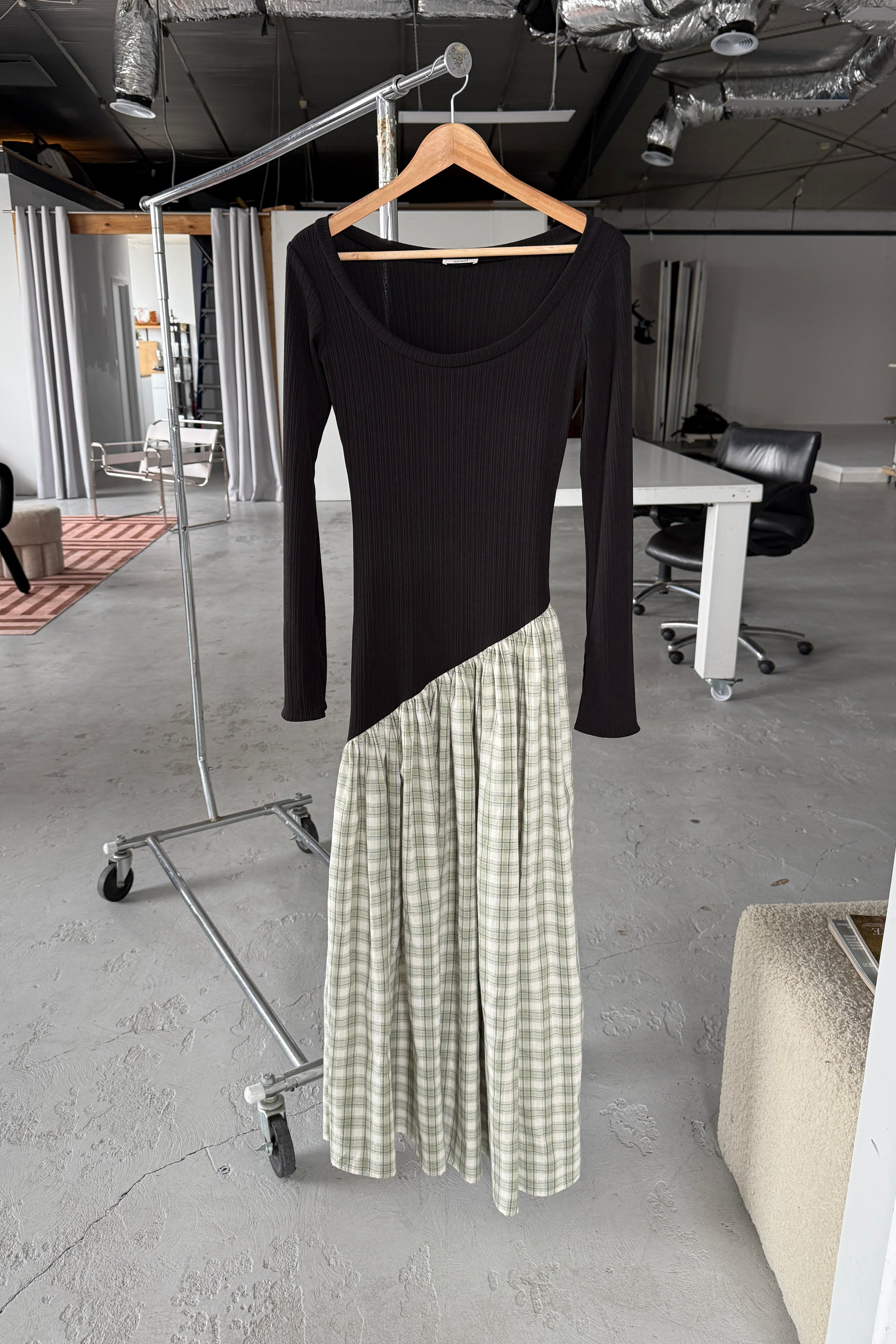 Long sleeve black maxi dress, with extra long sleeves, scooped neckline, and artfully gathered green plaid skirt. Top flatters the figure whilst the skirt flows with every movement. Can be dressed up or down.