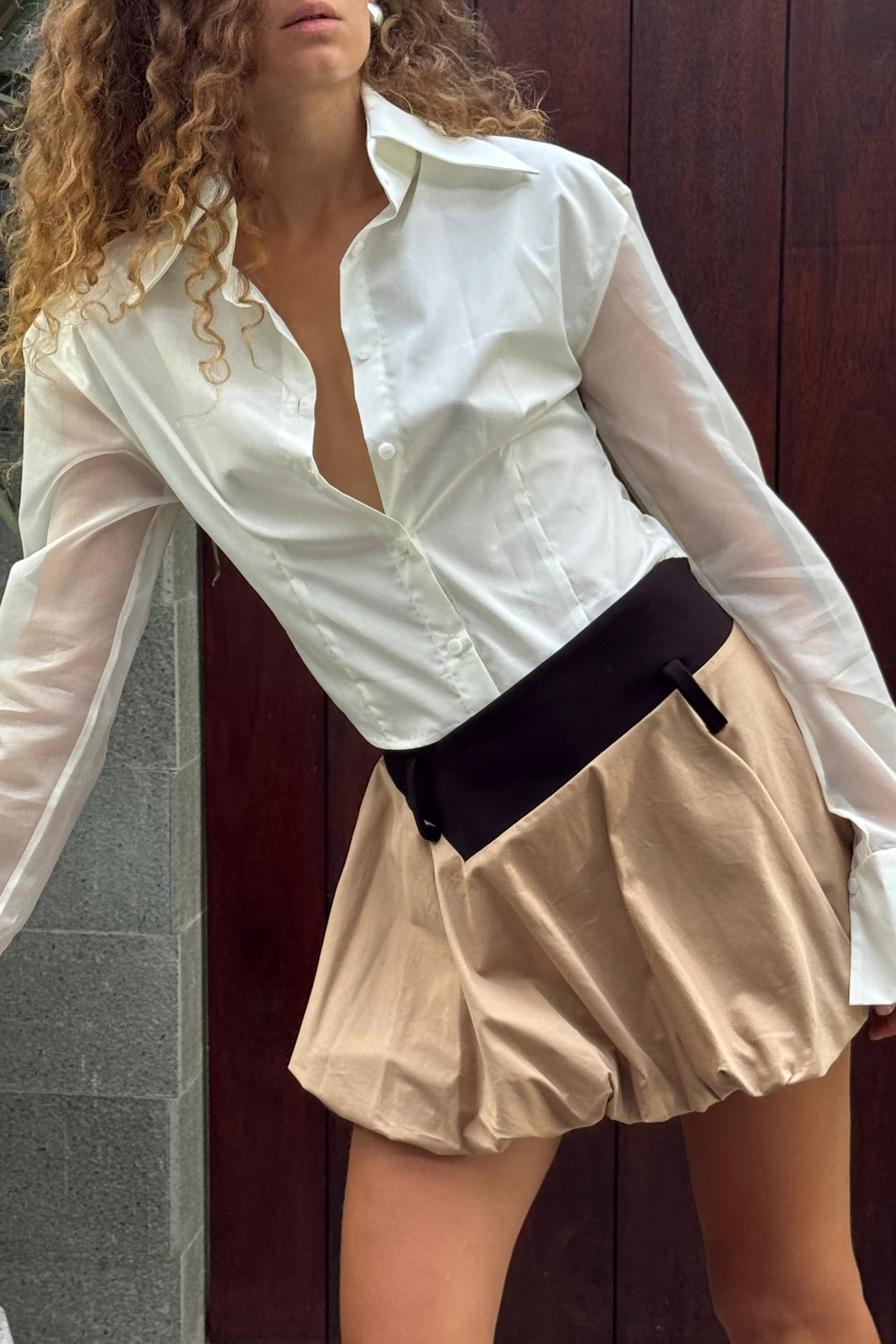 White button down shirt with silk organza sheer sleeves. Styled buttoned up with a beige balloon skirt. Perfect for the office or summer outings.