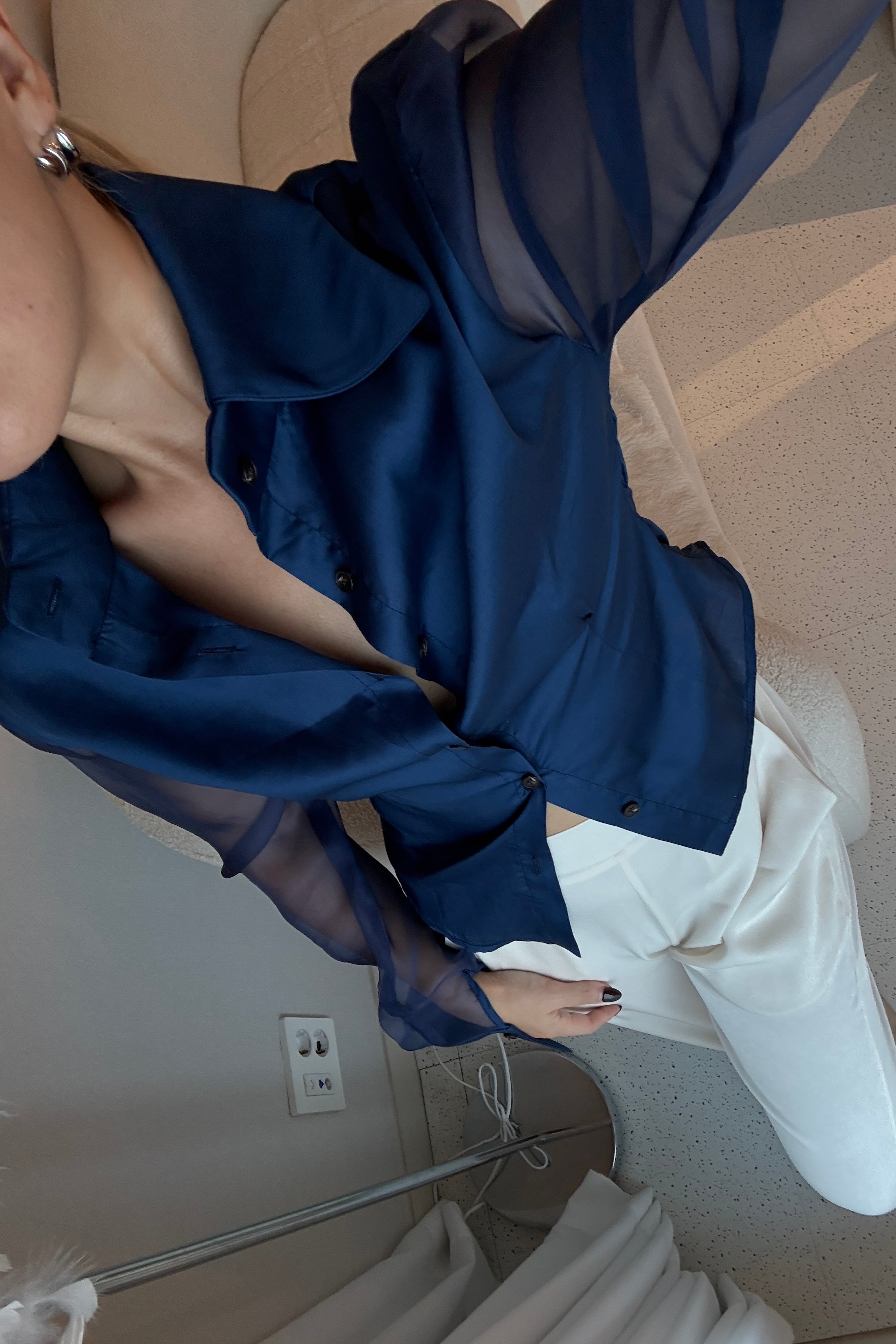 Royal navy blue button down shirt with silk organza sheer sleeves. Styled buttoned up with white pants. Perfect for the office or summer outings.