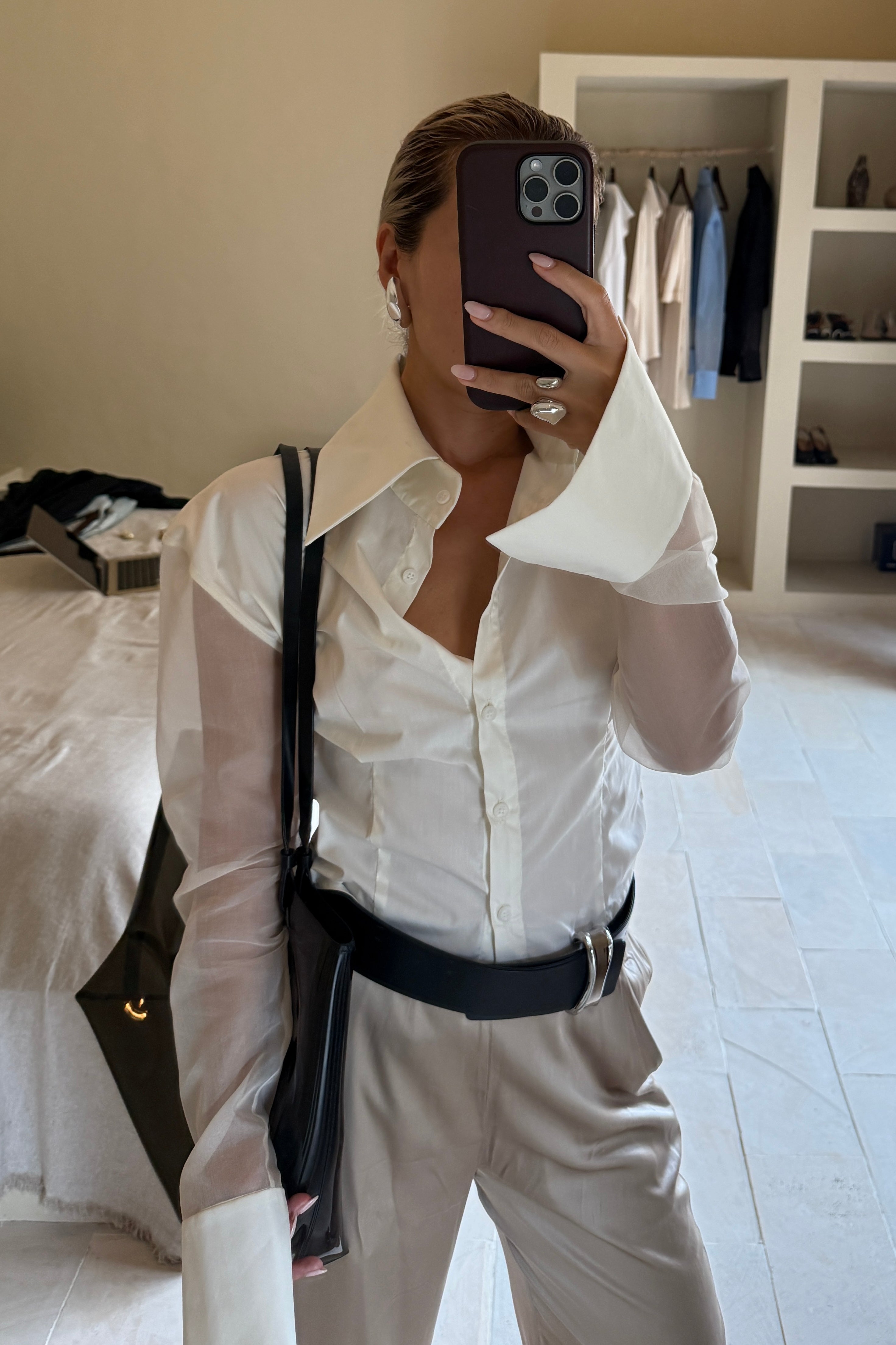 White button down shirt with silk organza sheer sleeves. Styled buttoned up with beige trousers. Perfect for the office or summer outings.