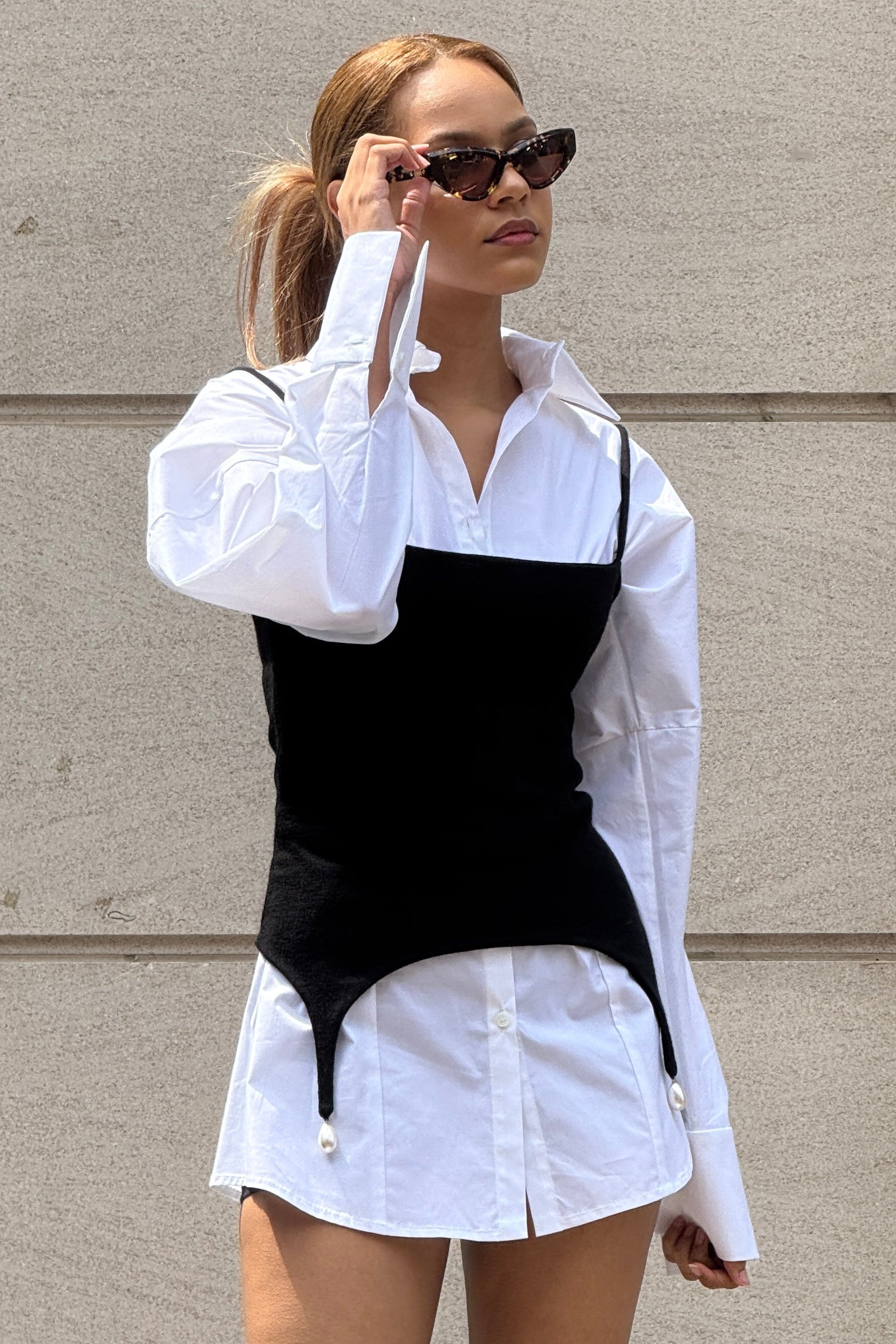 White volume sleeve shirt dress with form fitting black tank with pearl hem detail on top.