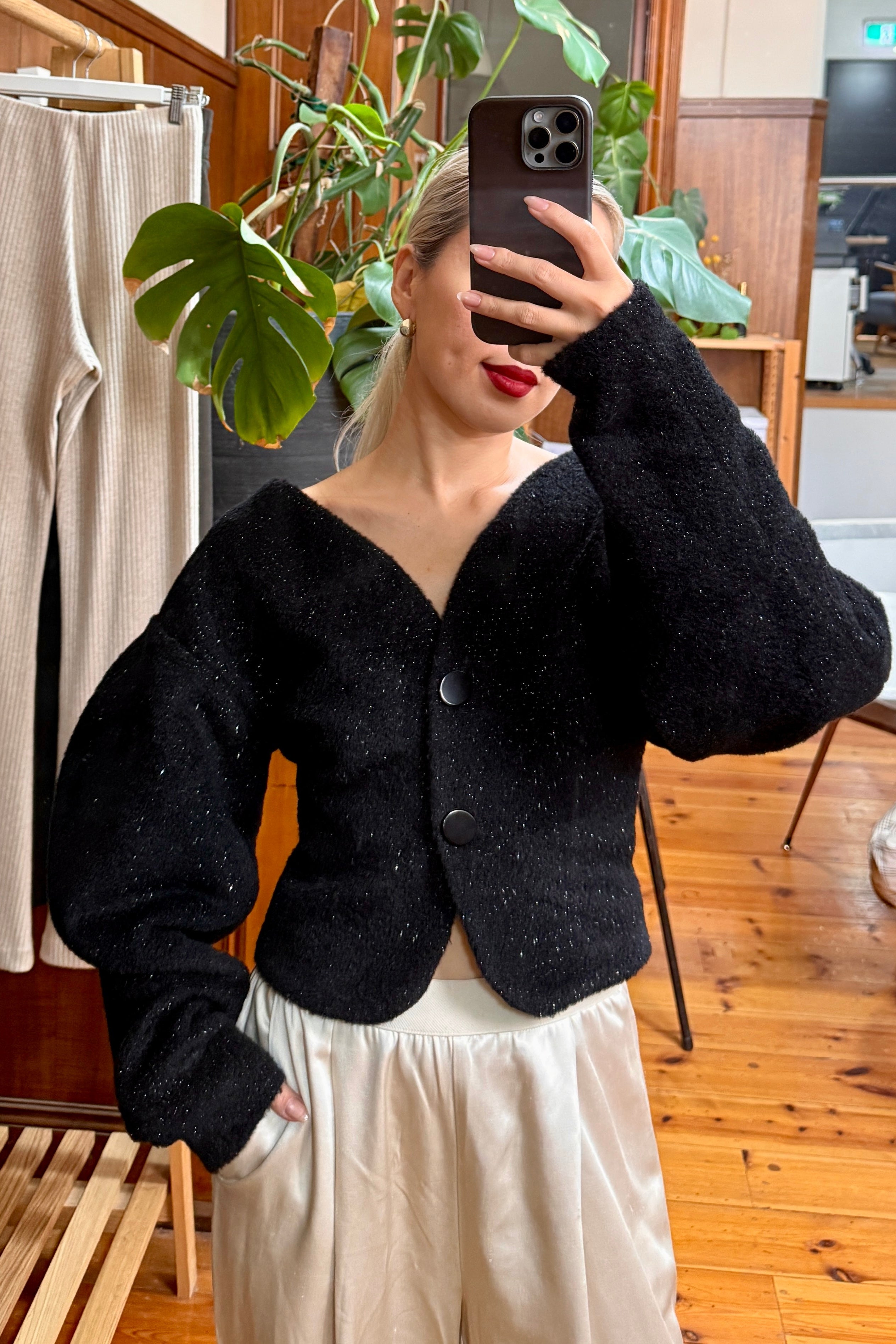 Black sparkly cardigan with voluminous sleeves. Paired with cream pants. Officewear essential.