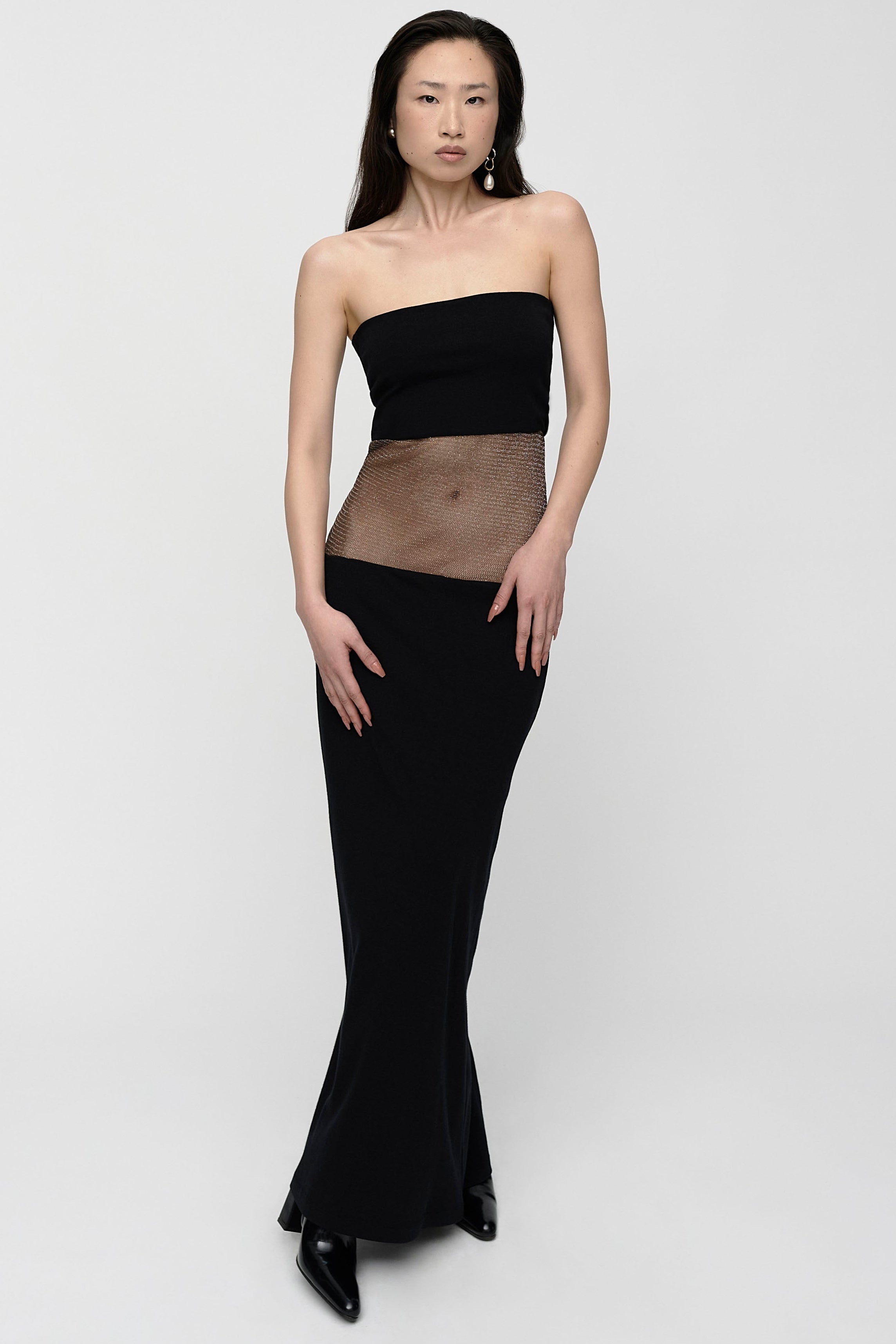 Woman in black strapless maxi dress with sparkly sheer panel in the mid section. Perfect for party's.