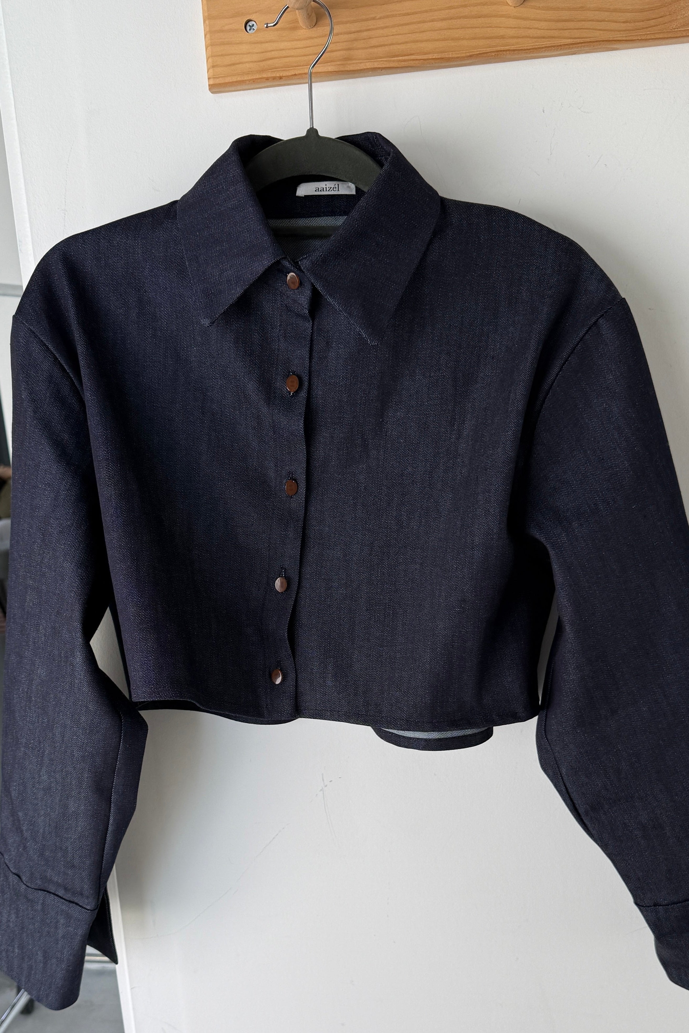 Boxy fit cropped denim jacket with button front closure. Hybrid of a shirt and a jacket.