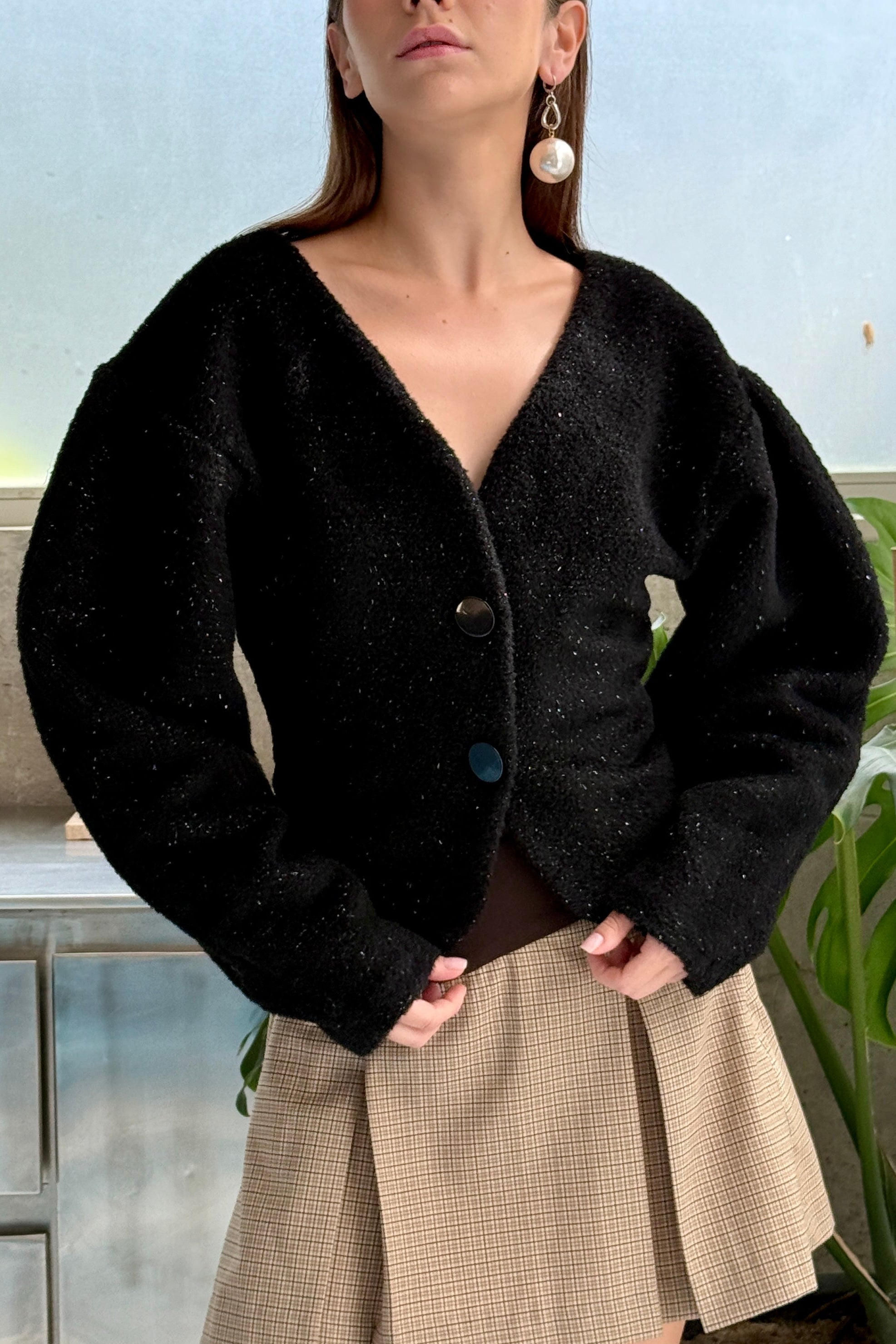 Black sparkly cardigan with voluminous sleeves. Paired with beige check mini skirt. Officewear essential.