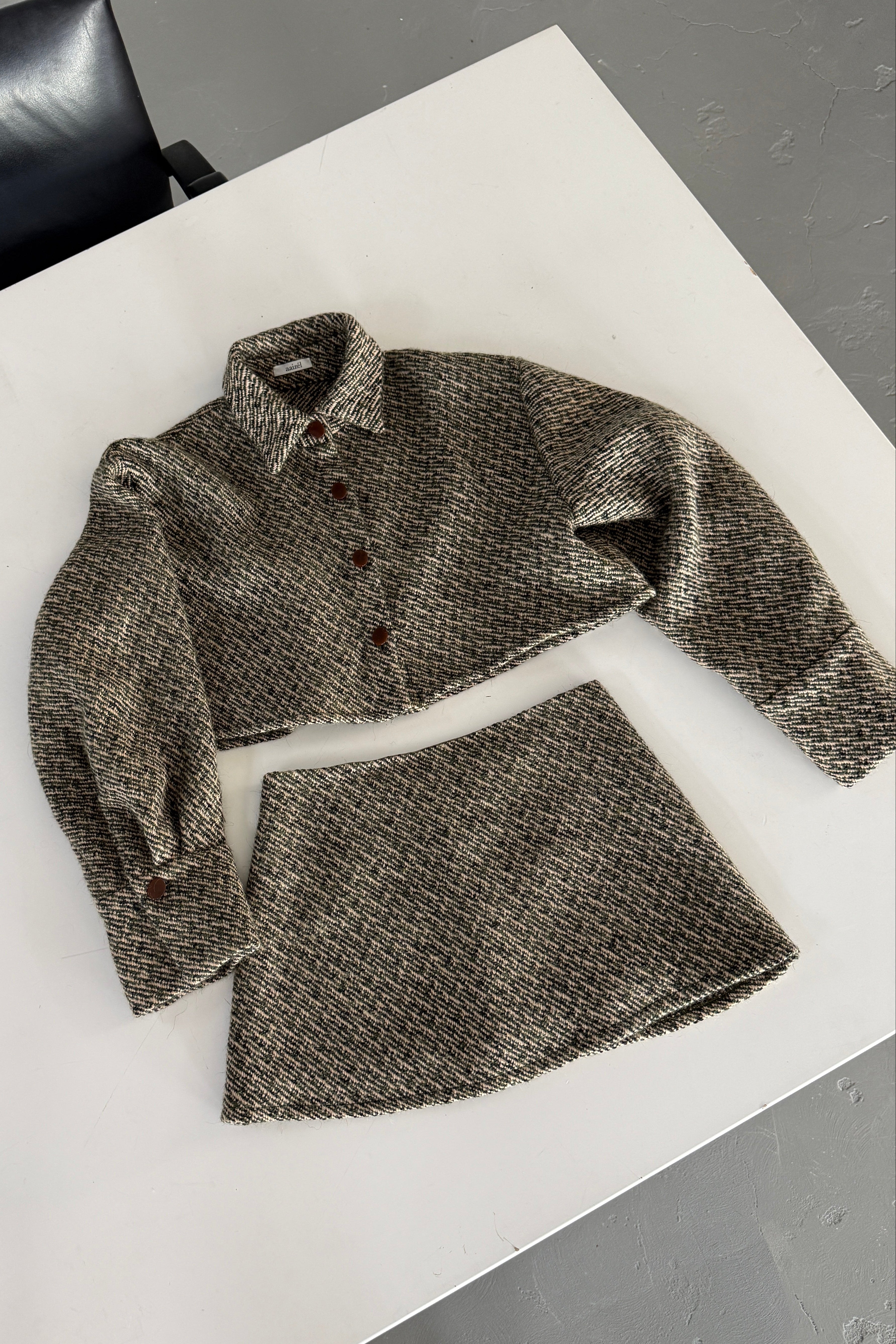 Olive wool bouclé mini skirt with matching boxy fit cropped jacket.